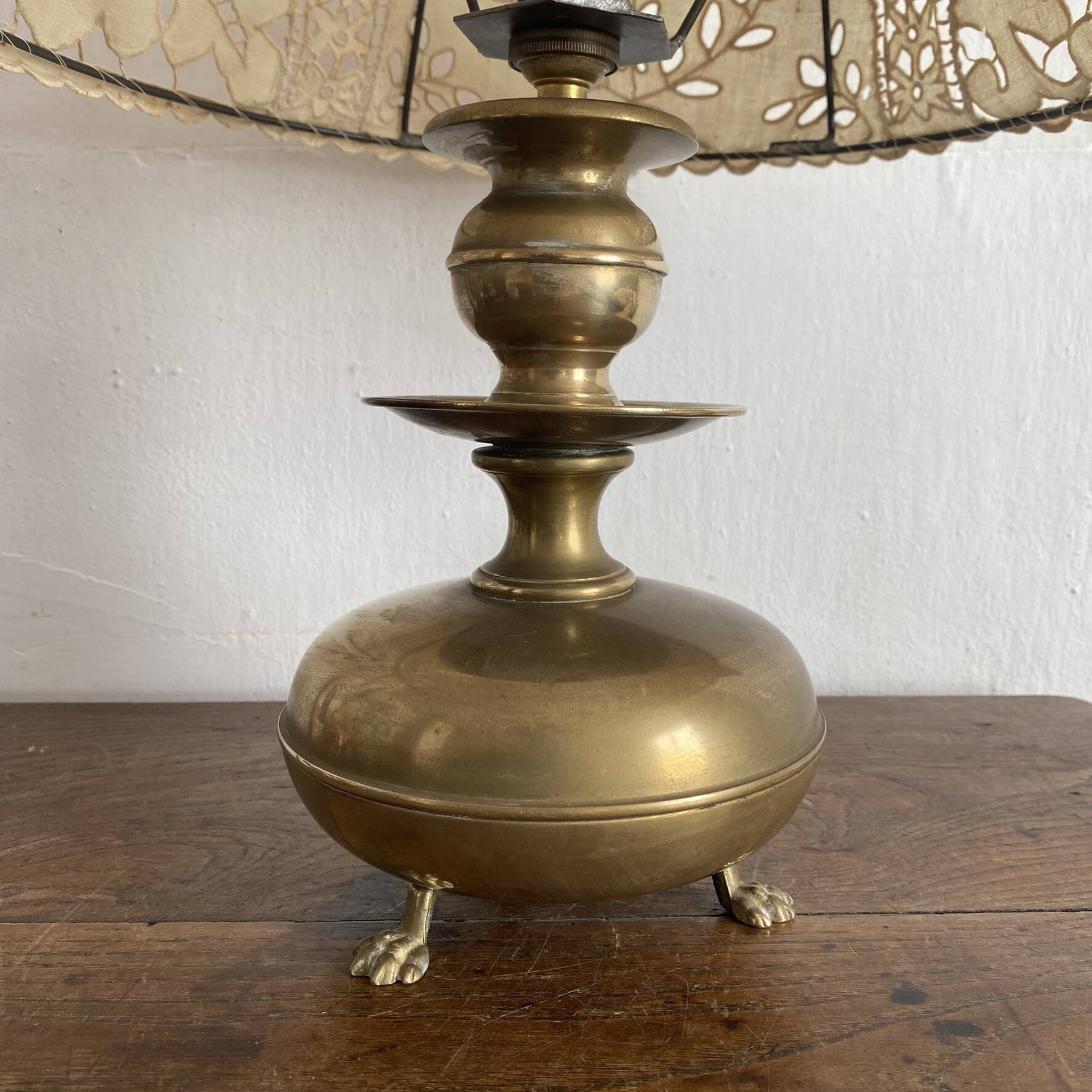 Antique brass lamp with embroidered openwork shade.