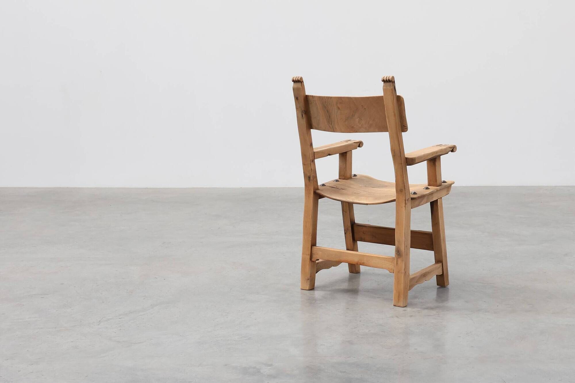 Brutalist armchair with carved rosettes and nailed wooden seat, Spain