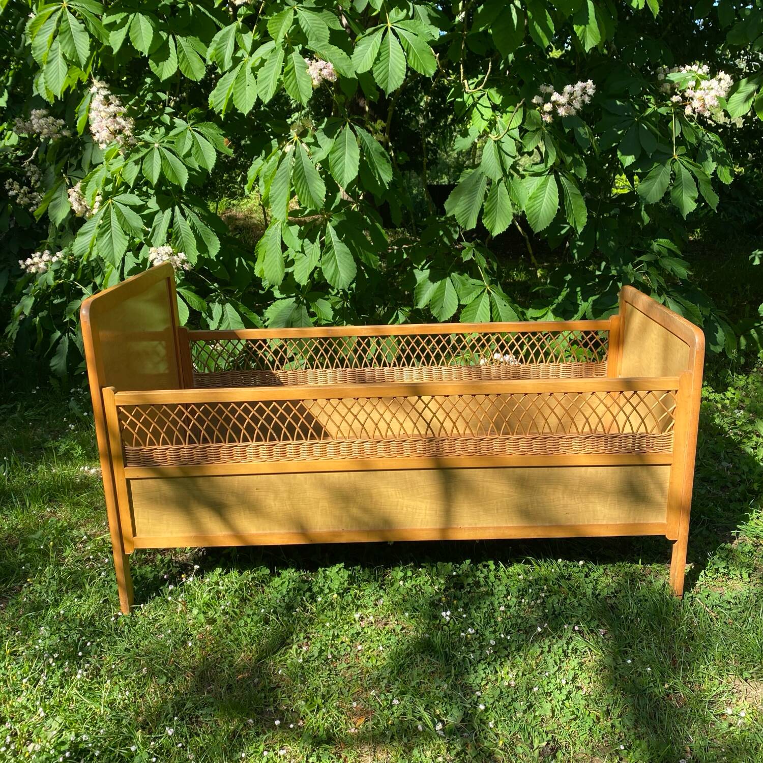 Vintage wooden and rattan baby cot from the 1960s.