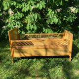 Vintage wooden and rattan baby cot from the 1960s.