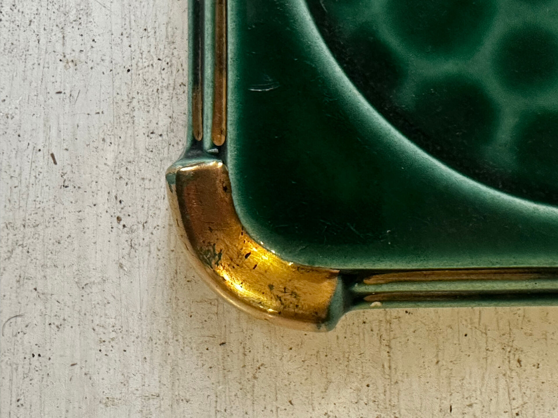 Art Deco bottle coaster in speckled green glazed ceramic and