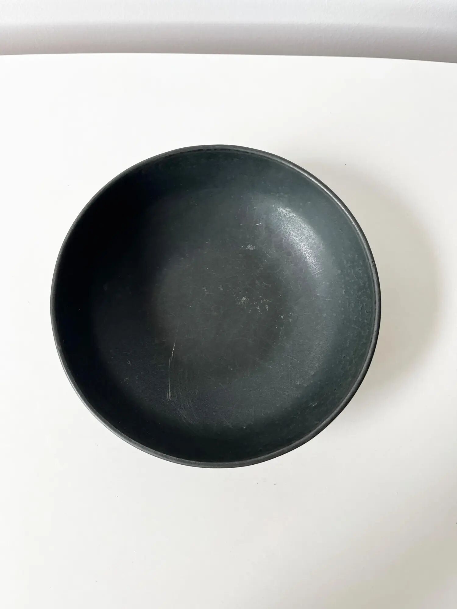 Round vintage black ceramic catchall.
