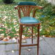 Bar stool in green leather and curved wood