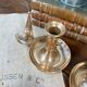 Duo of brass cellar rat candlesticks with extinguisher
