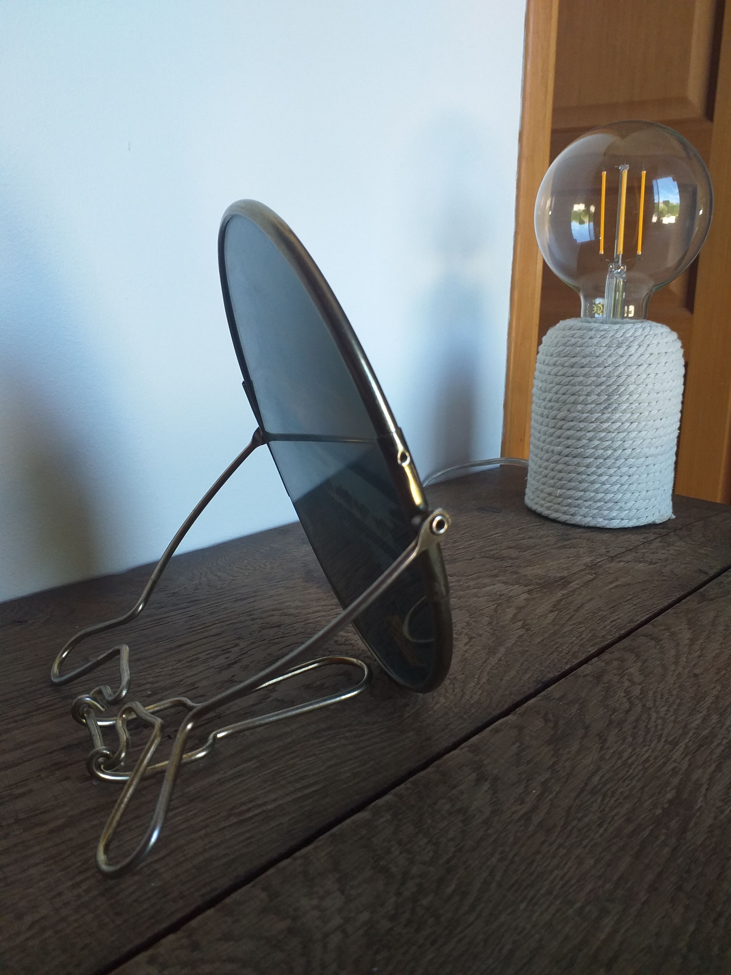 Vintage oval mirror on suspended stand