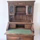 Large secretary with a drop-down front in carved oak, neo-Renaissance style.
