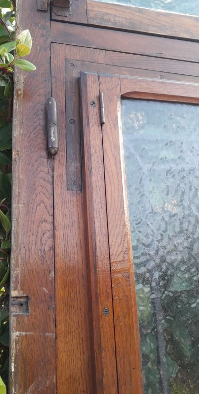 Oak entrance door and its frame and transom, wrought iron gates