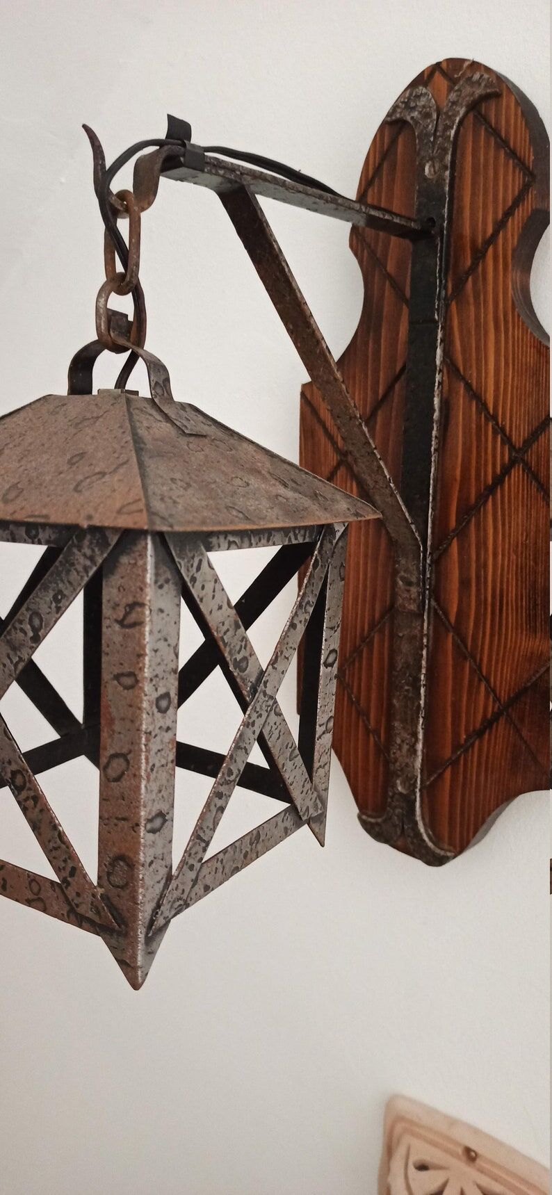 Wall lamp in wrought iron and old wood