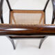 Mid-century curved wooden chairs with cane seats and backs.