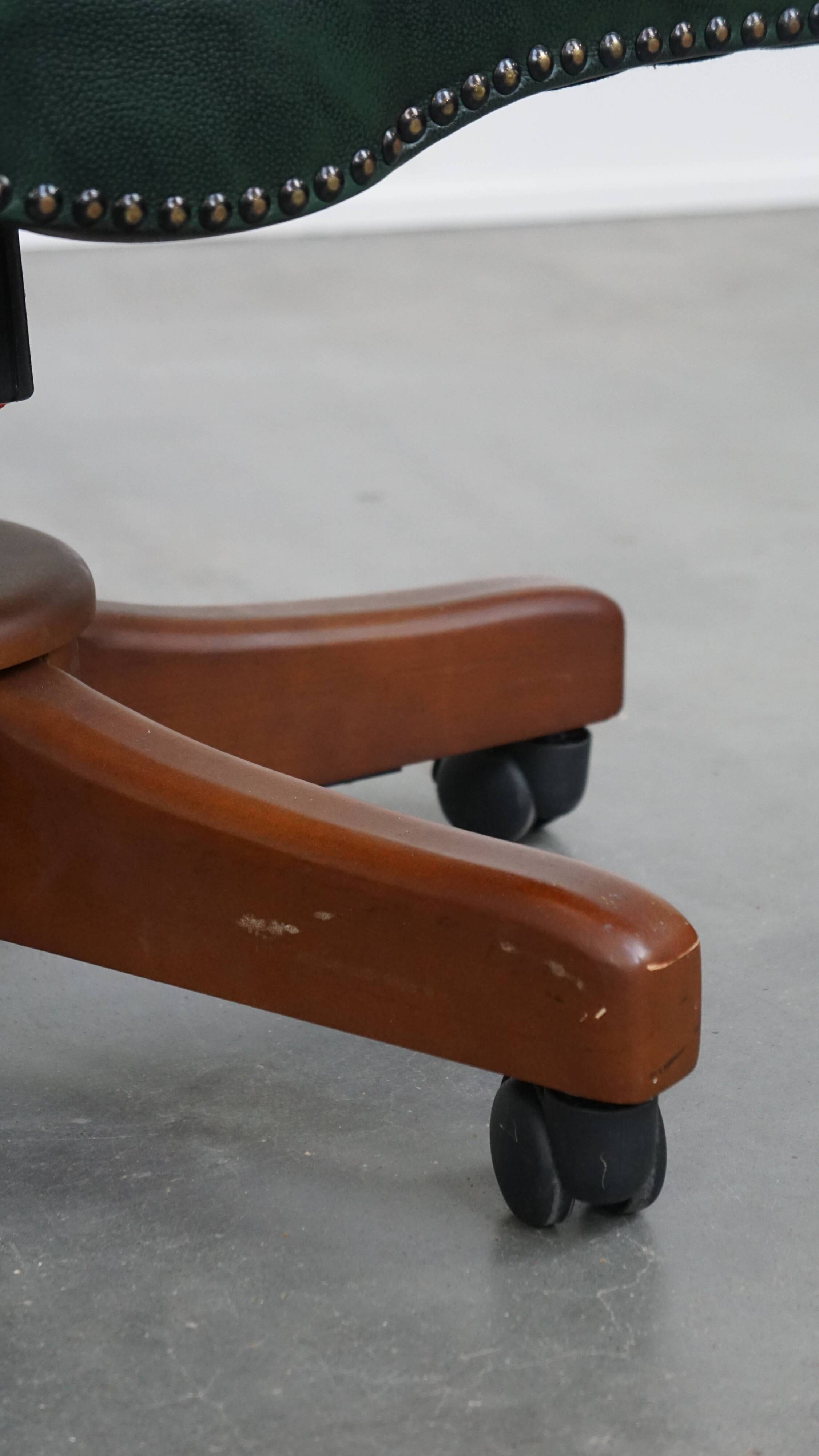 Dark green chesterfield office chair in cowhide leather on wheels