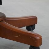 Dark green chesterfield office chair in cowhide leather on wheels