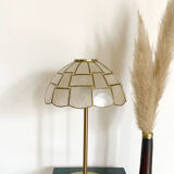 Table lamp with a lampshade with mother-of-pearl set with checkerboard brass and a gilded foot