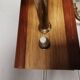 A set of wall lamps in teak wood, with amber colored glass