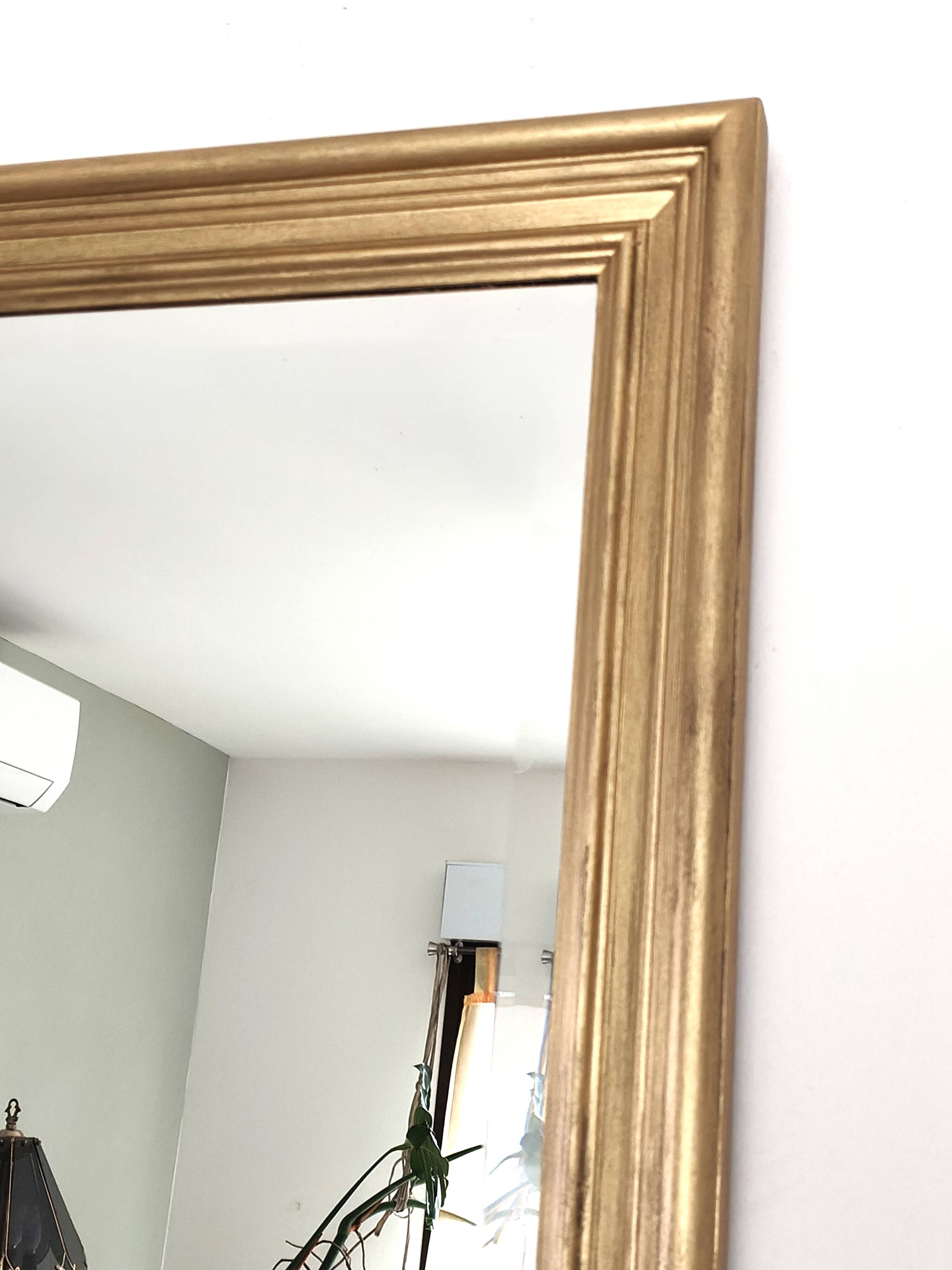 Large gold-framed mirror with bevelled glass.