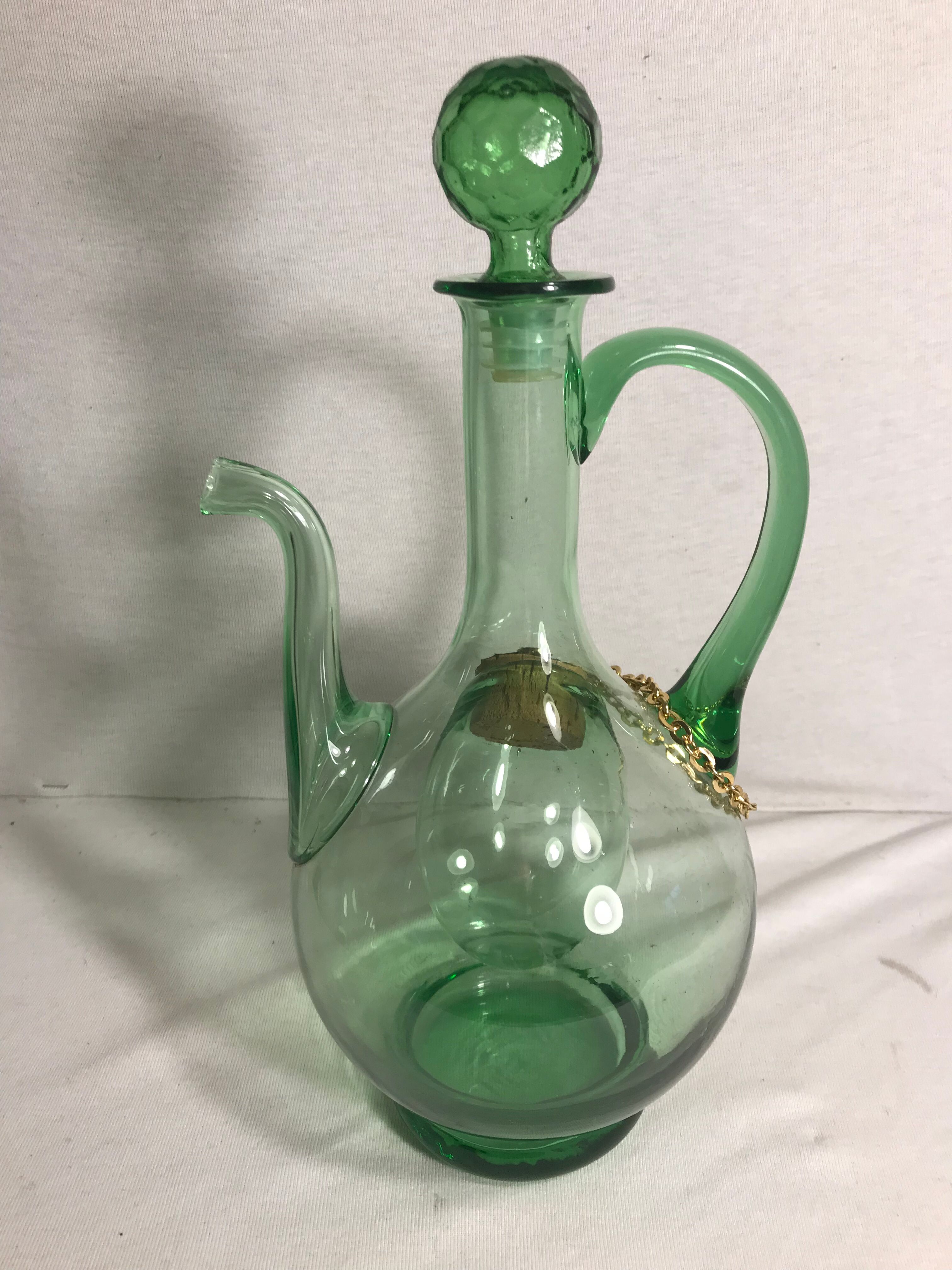 Old refreshing carafe pourer in green blown glass with vintage cap