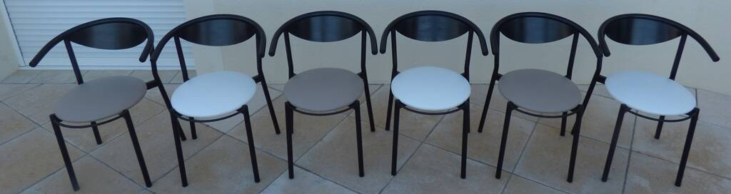 6 gondola-style chairs with a sturdy metal frame and faux leather.