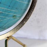 Luminous world map in tripod glass