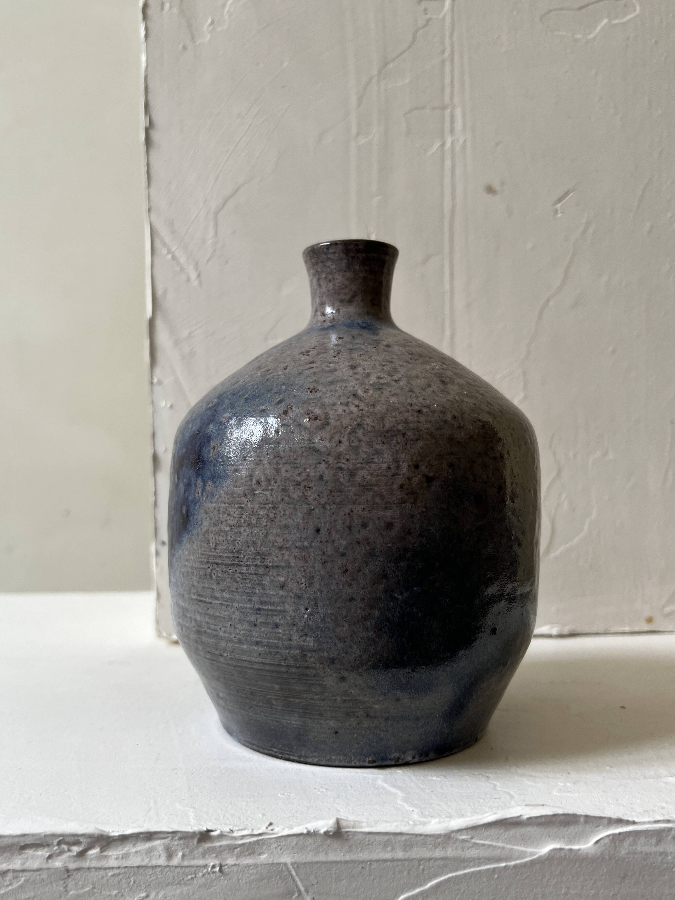 Glazed ceramic vase with a narrow neck and signed, unique piece.