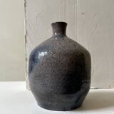 Glazed ceramic vase with a narrow neck and signed, unique piece.