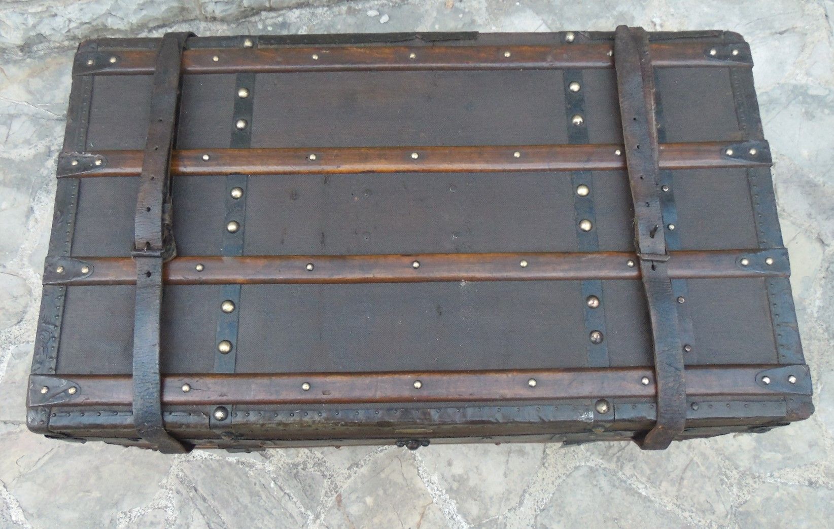 Old wooden and leather trunk, old brass nail trunk and leather strap
