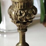 Baroque/Antique style torch candleholder, nineteenth, gilded bronze. Head motifs, volute arabesques