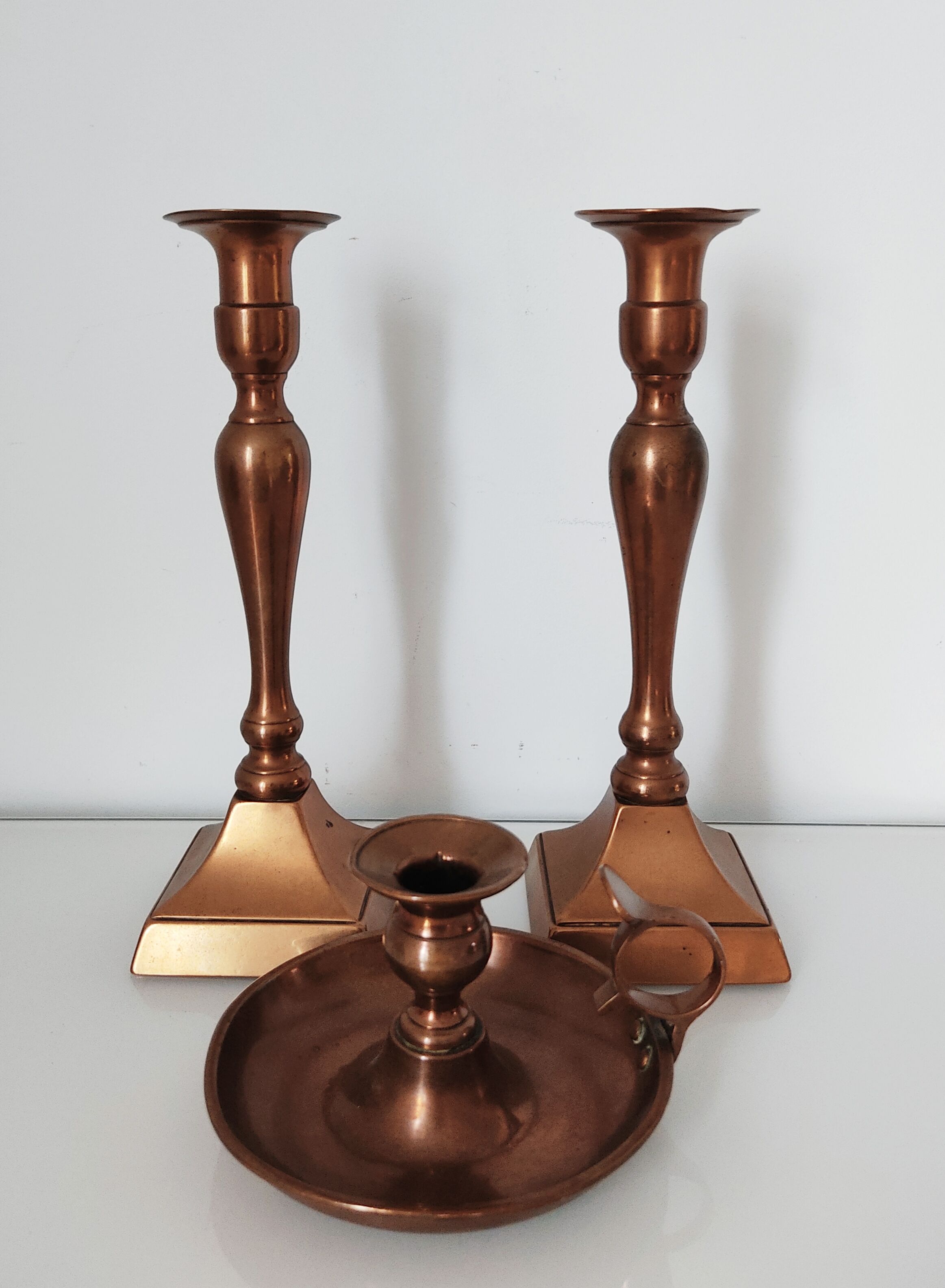 Set of a pair of candle holders and a hand candle holder