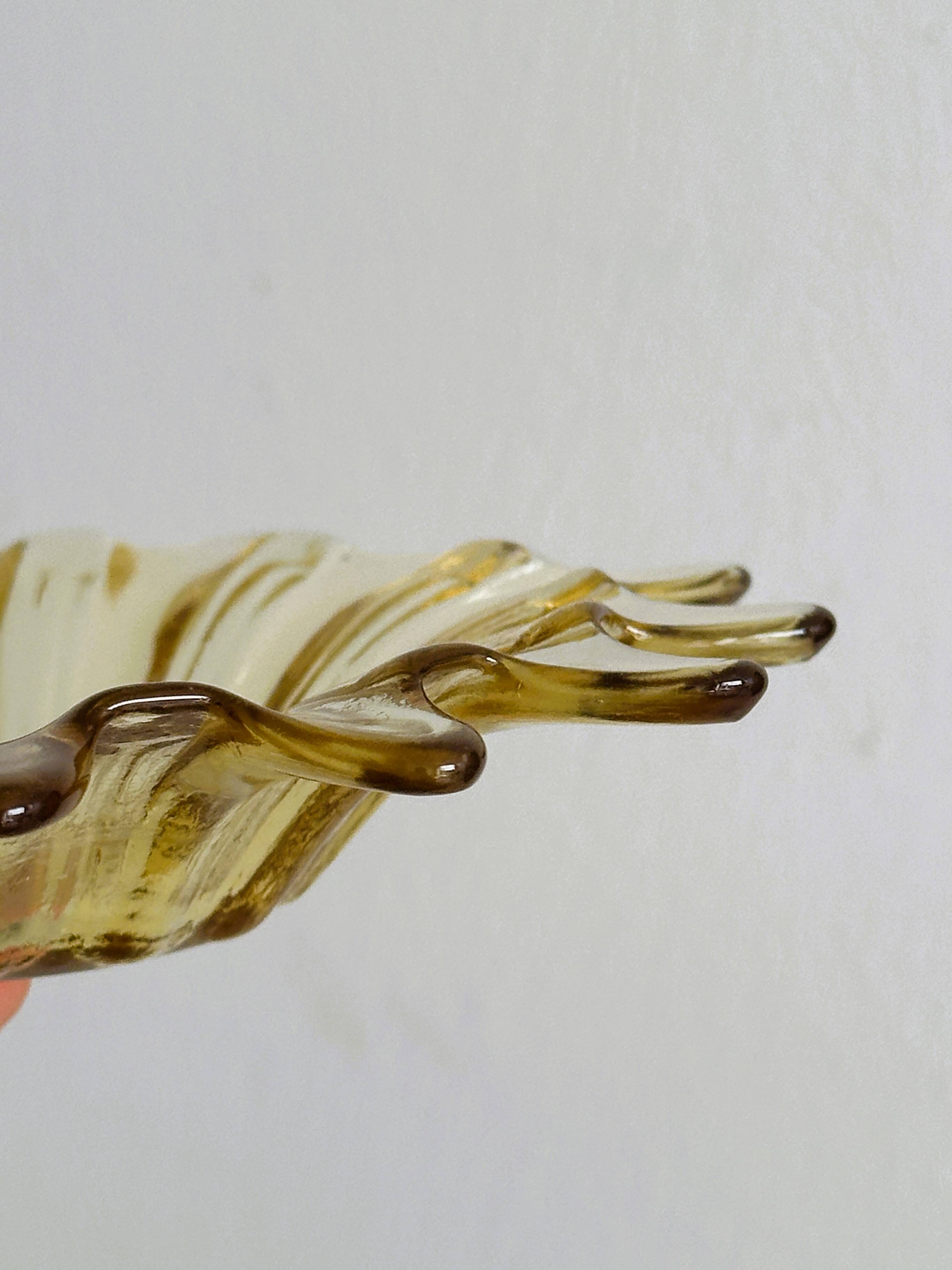 Empty pocket in yellow translucent blown glass, ashtray.