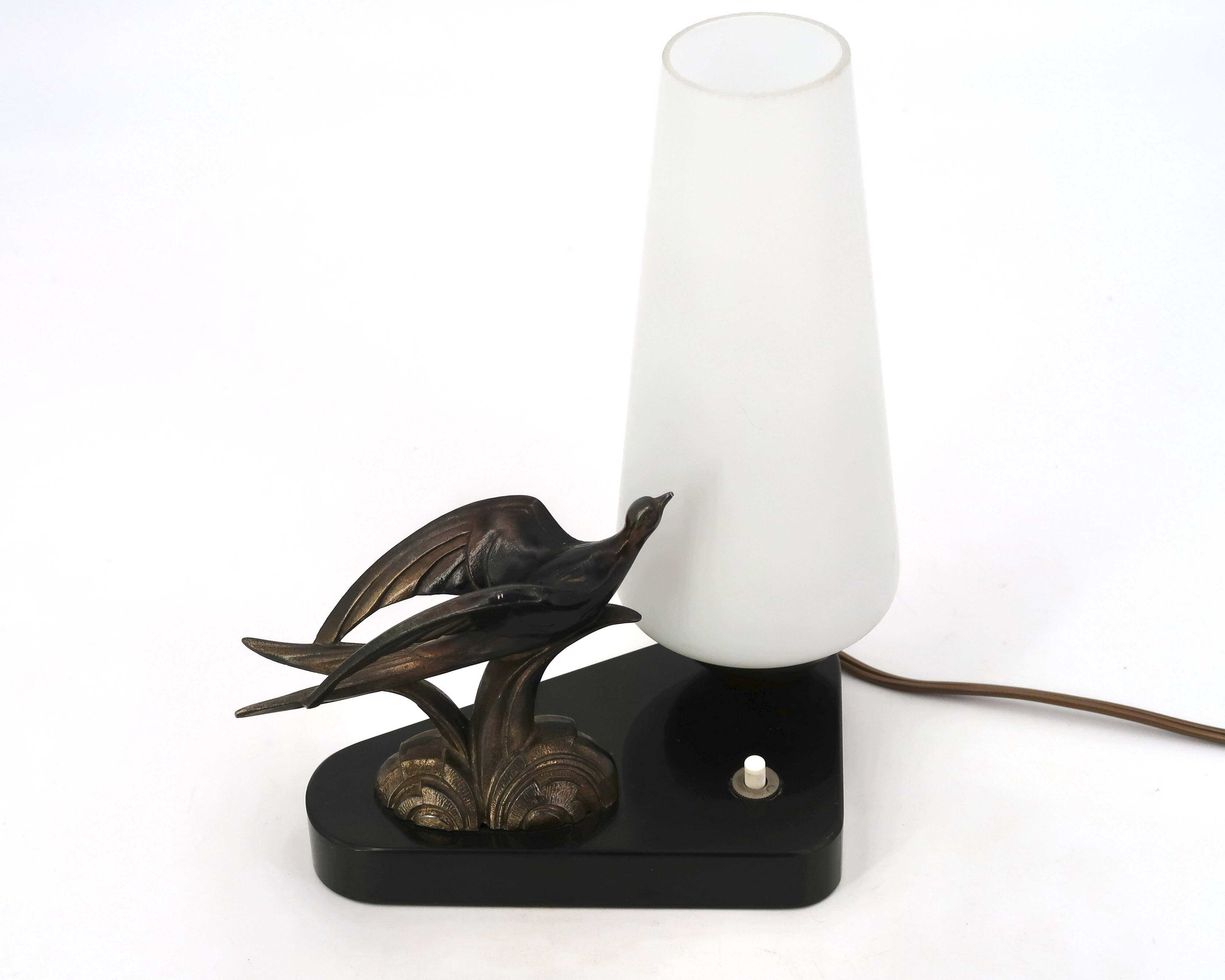 Art Deco lamp with swallow sculpture, marble base, opaque white globe.