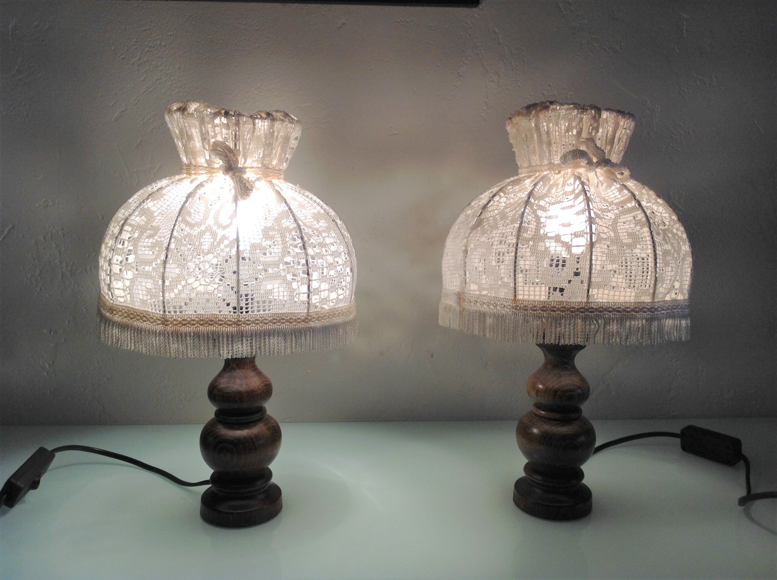 Pair of turned wooden bedside lamps and lace/vintage lampshade 60s-70s