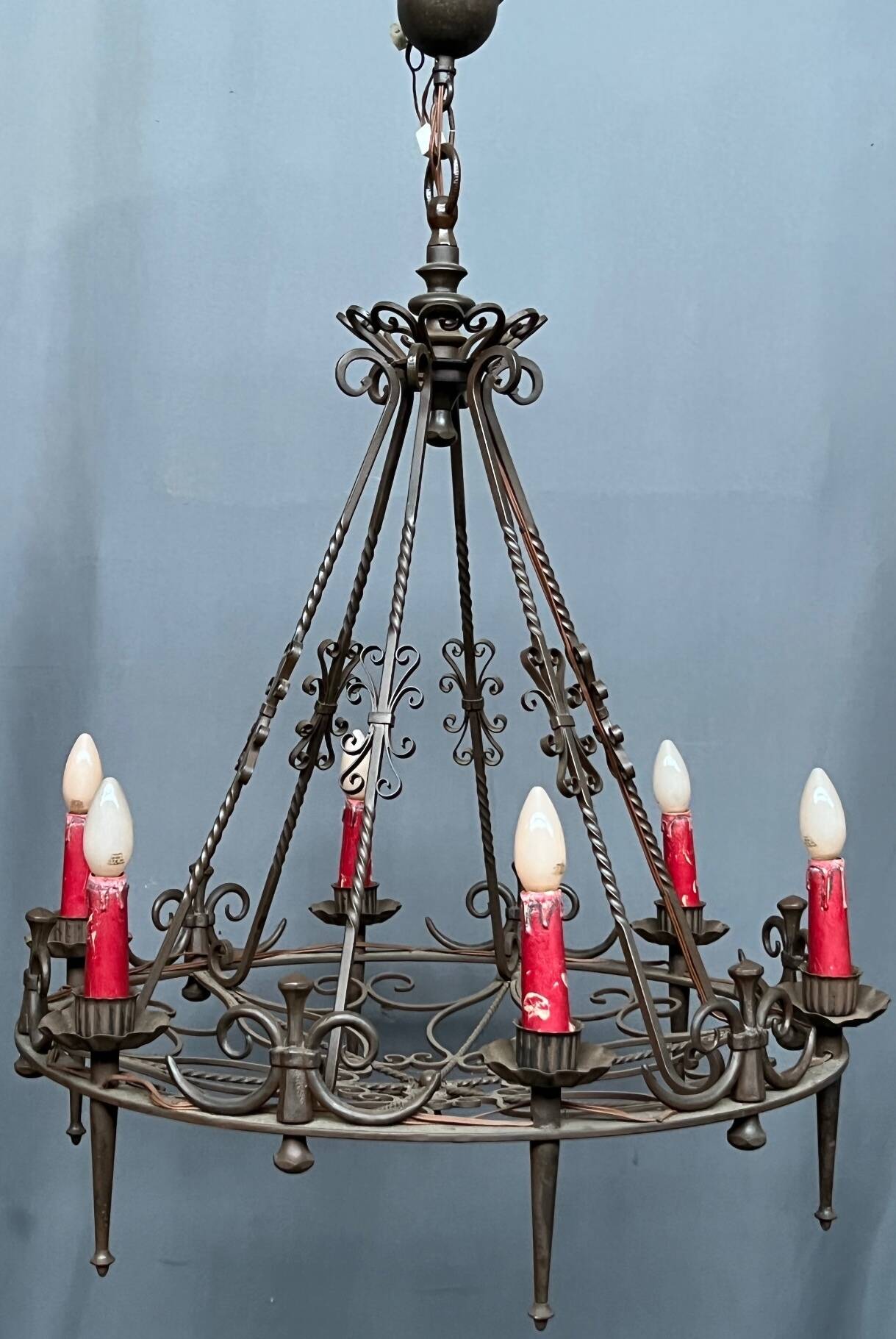 Wrought chandelier in Gothic style.
