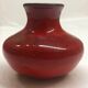 Red ceramic ball vase signed A