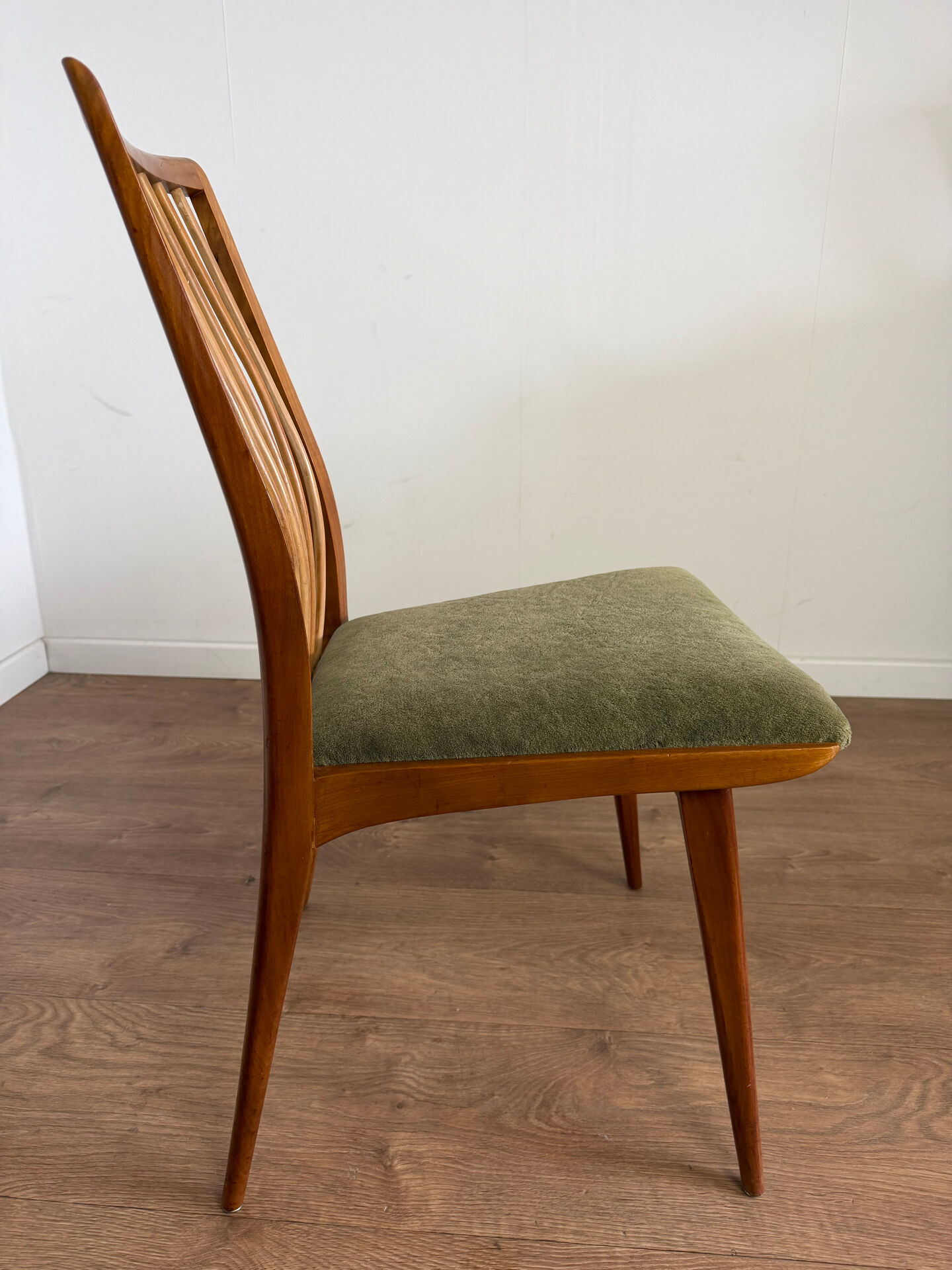 Scandinavian chairs with green velvet upholstery.