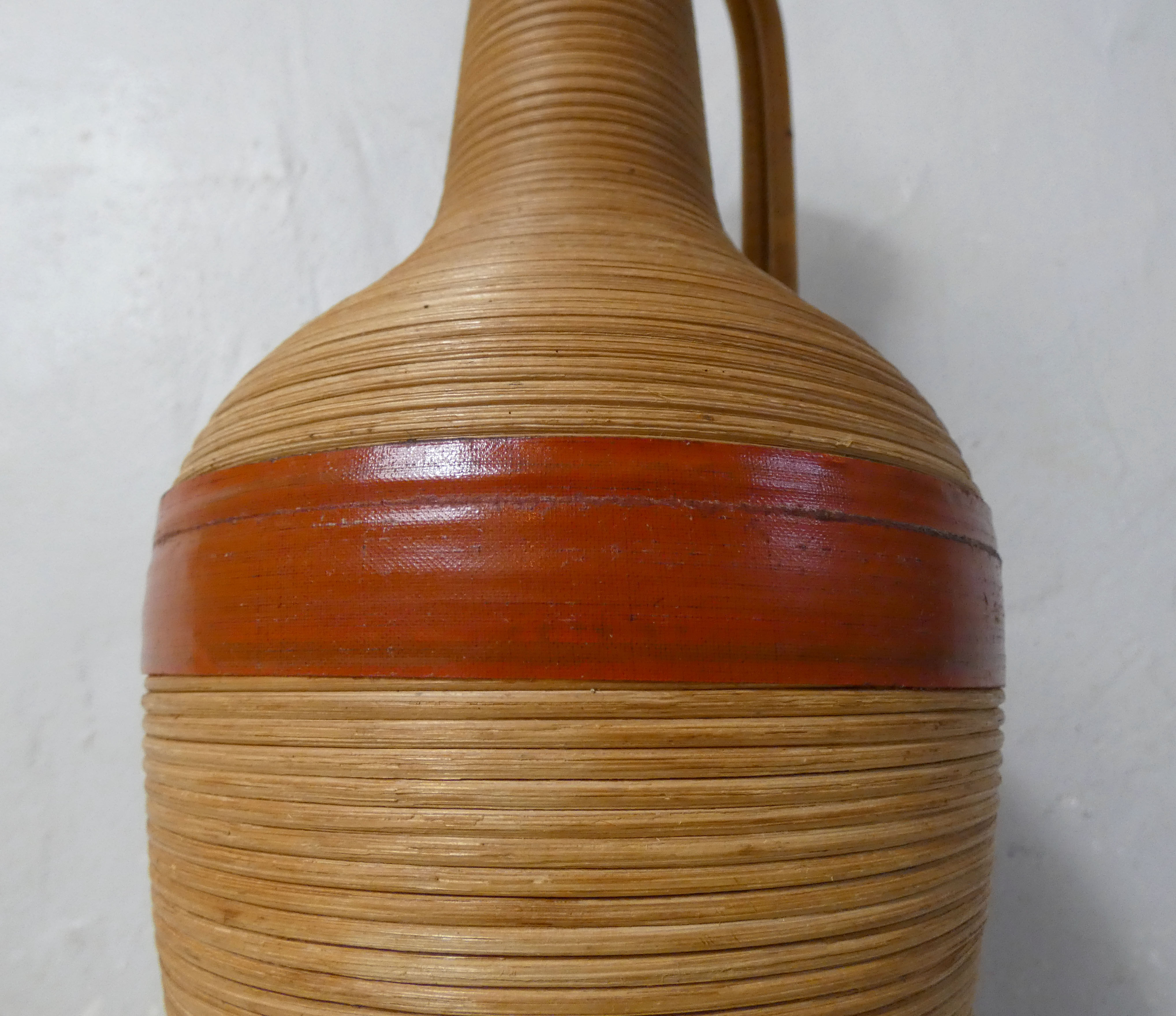 Old bottle dressed in vintage wood rattan