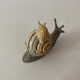 Porcelain figurine snail and its small
