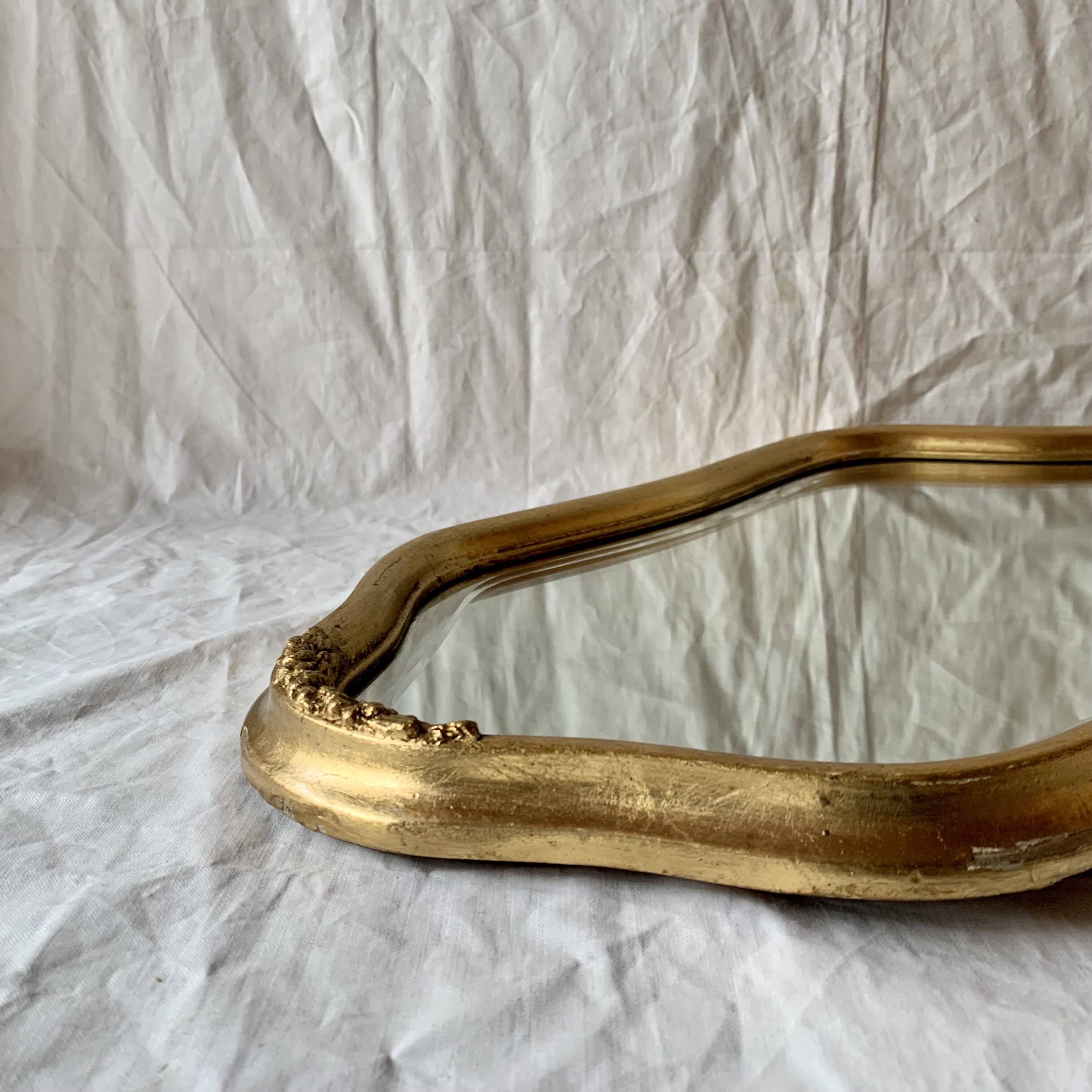 Antique beveled wall mirror in gilded solid wood