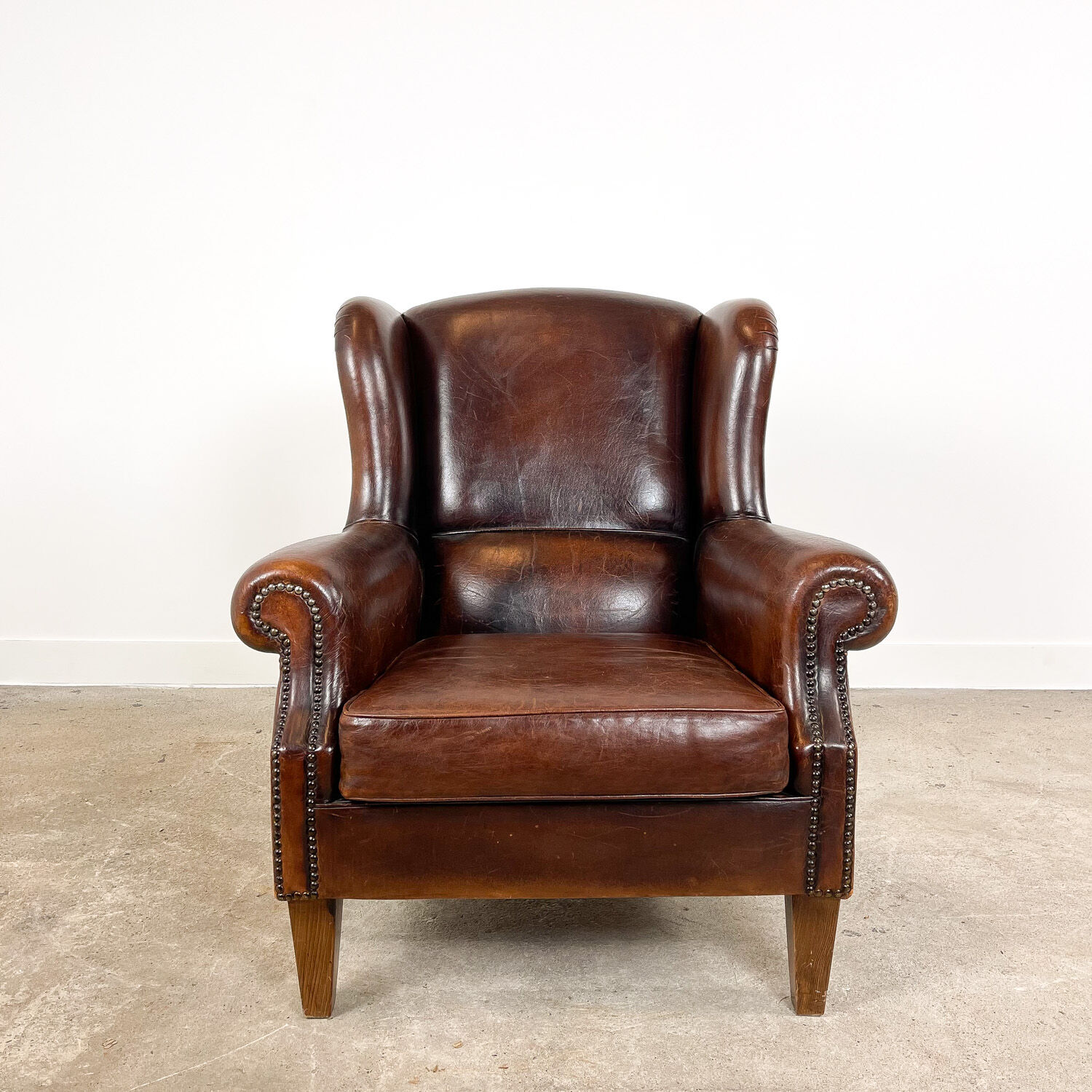 Vintage dark brown sheep leather wingback armchair