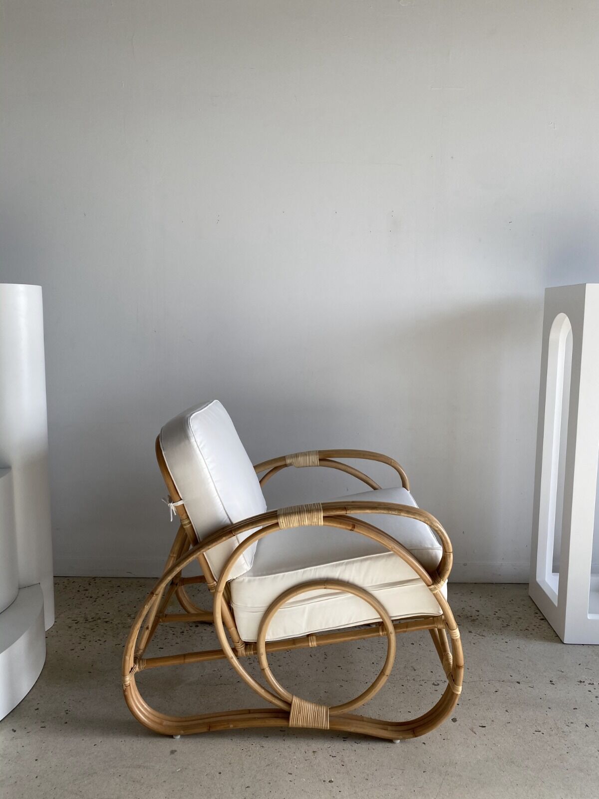 Large rattan rest chair and white cushions