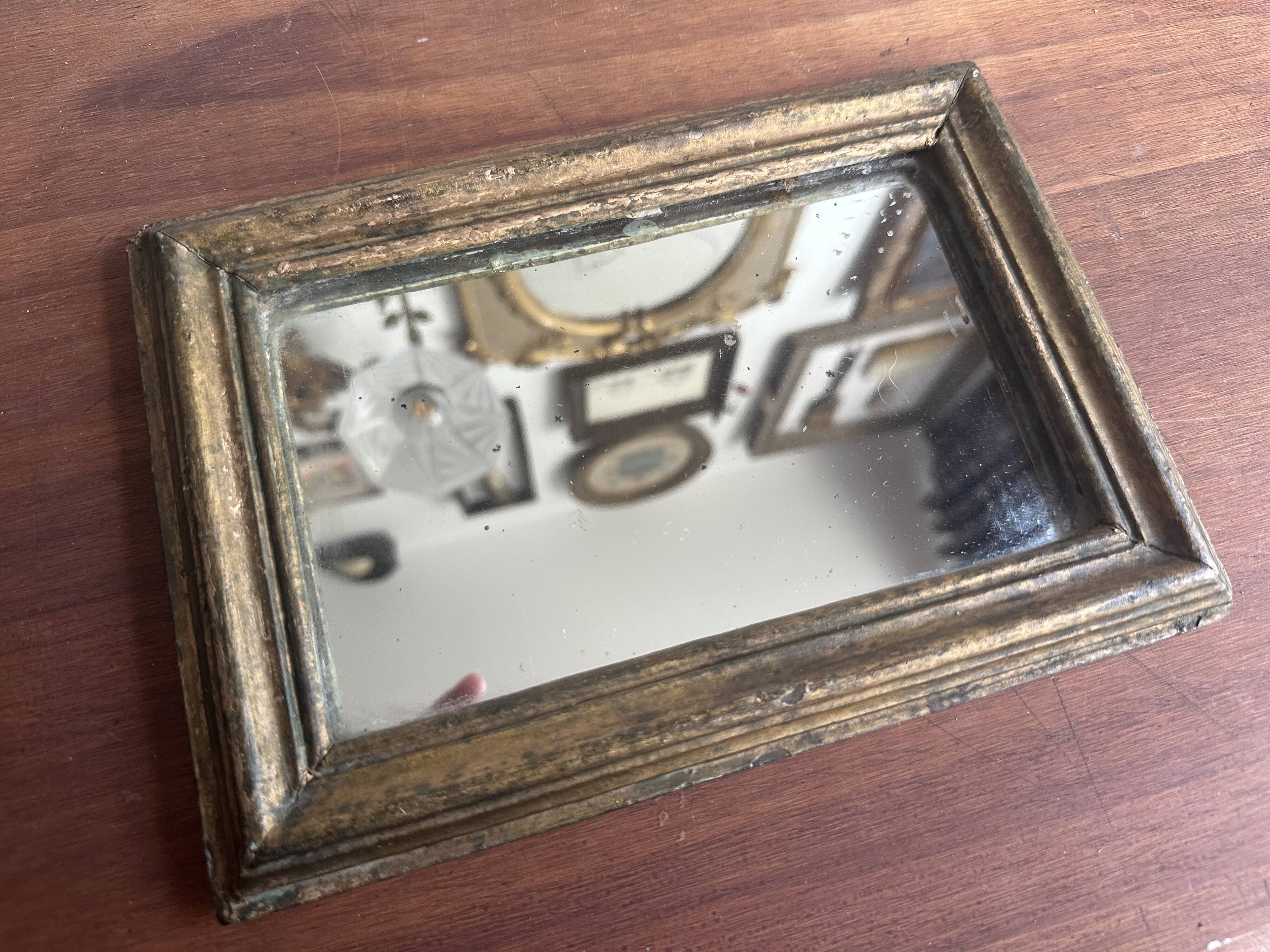 Miniature mirror from the 18th century in gilded wood, mercury glass.