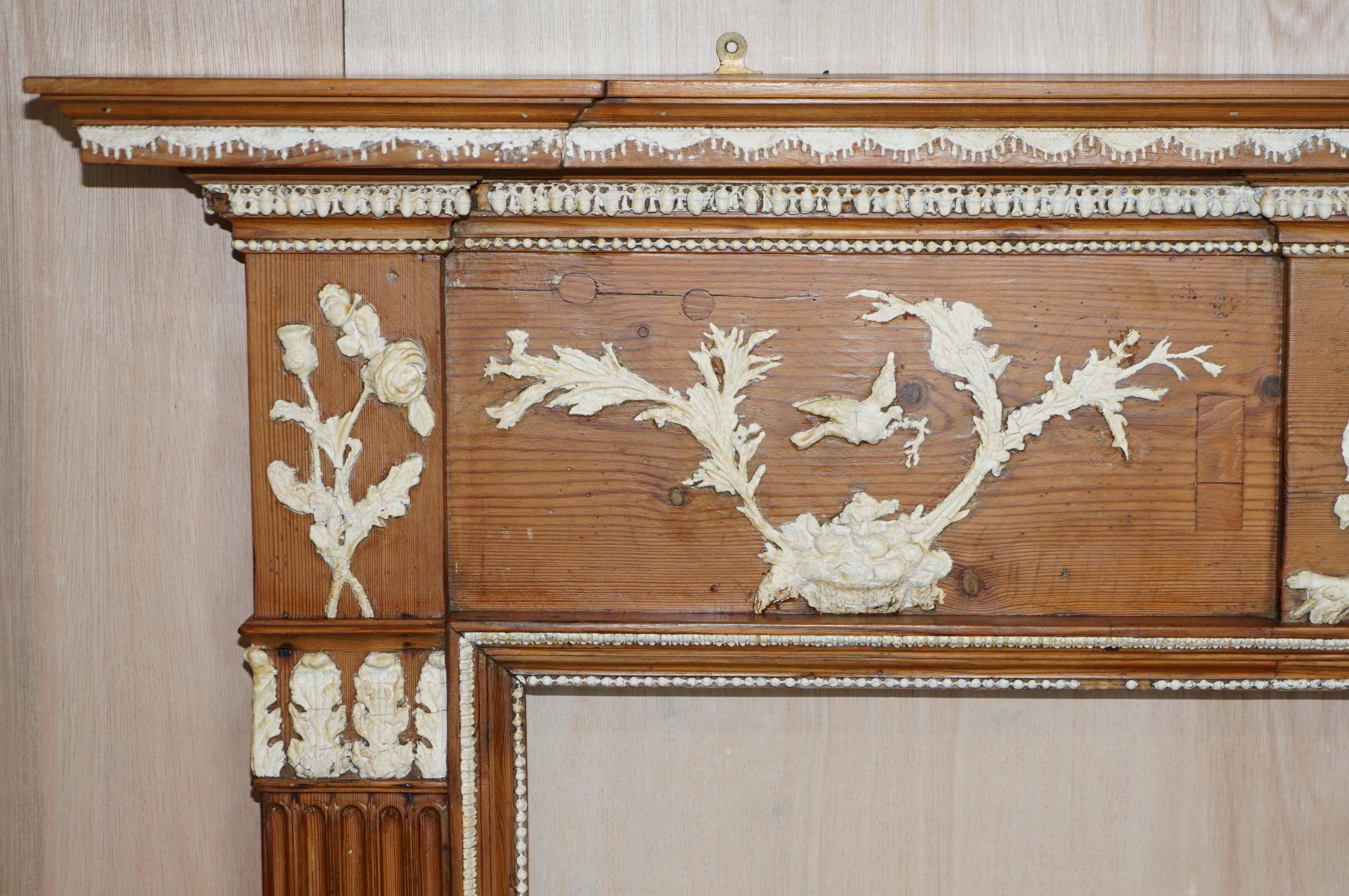 Victorian antique fireplace in tarred pine and sculpted gesso.