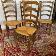 Set of 5 antique solid oak chairs with straw seats.