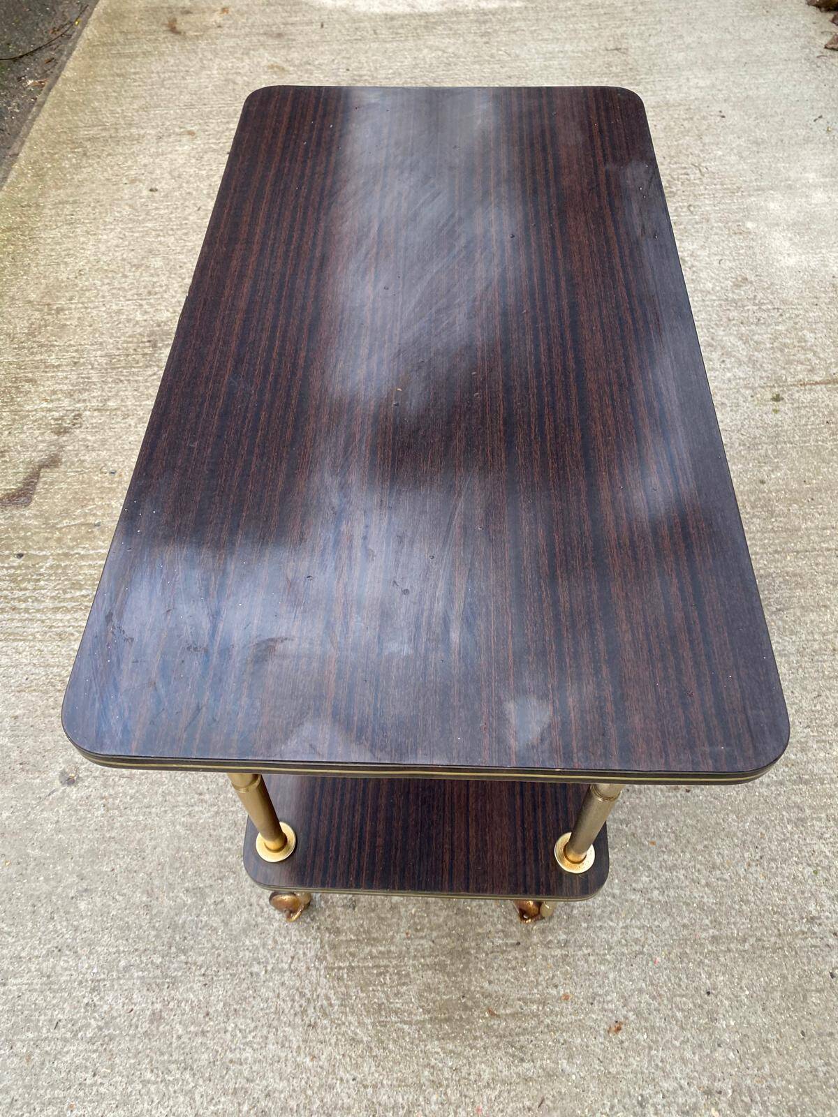 Brown rosewood rolling table with gold legs