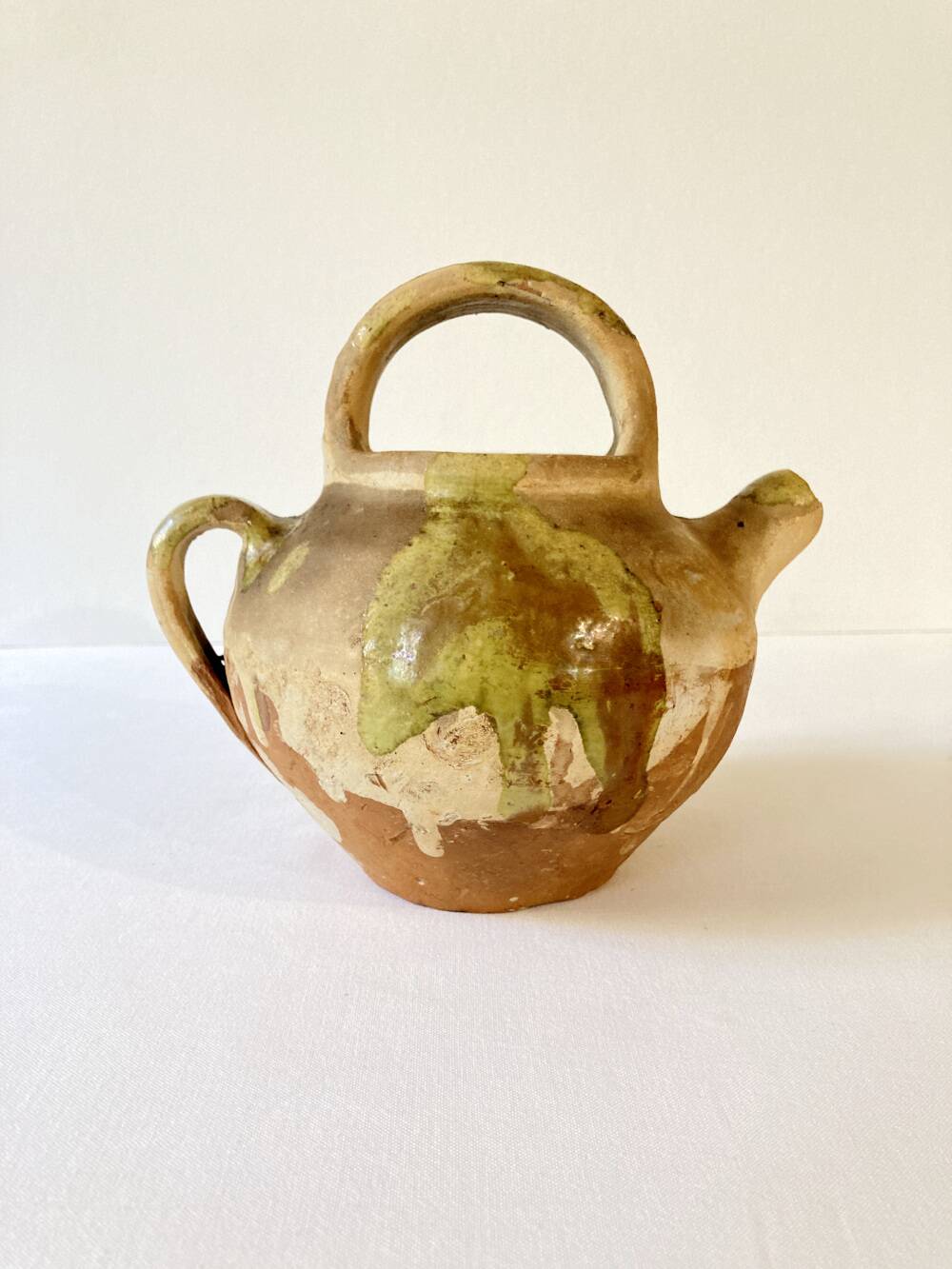 Small Provençal goat jug in creamy white and green enamelled stoneware