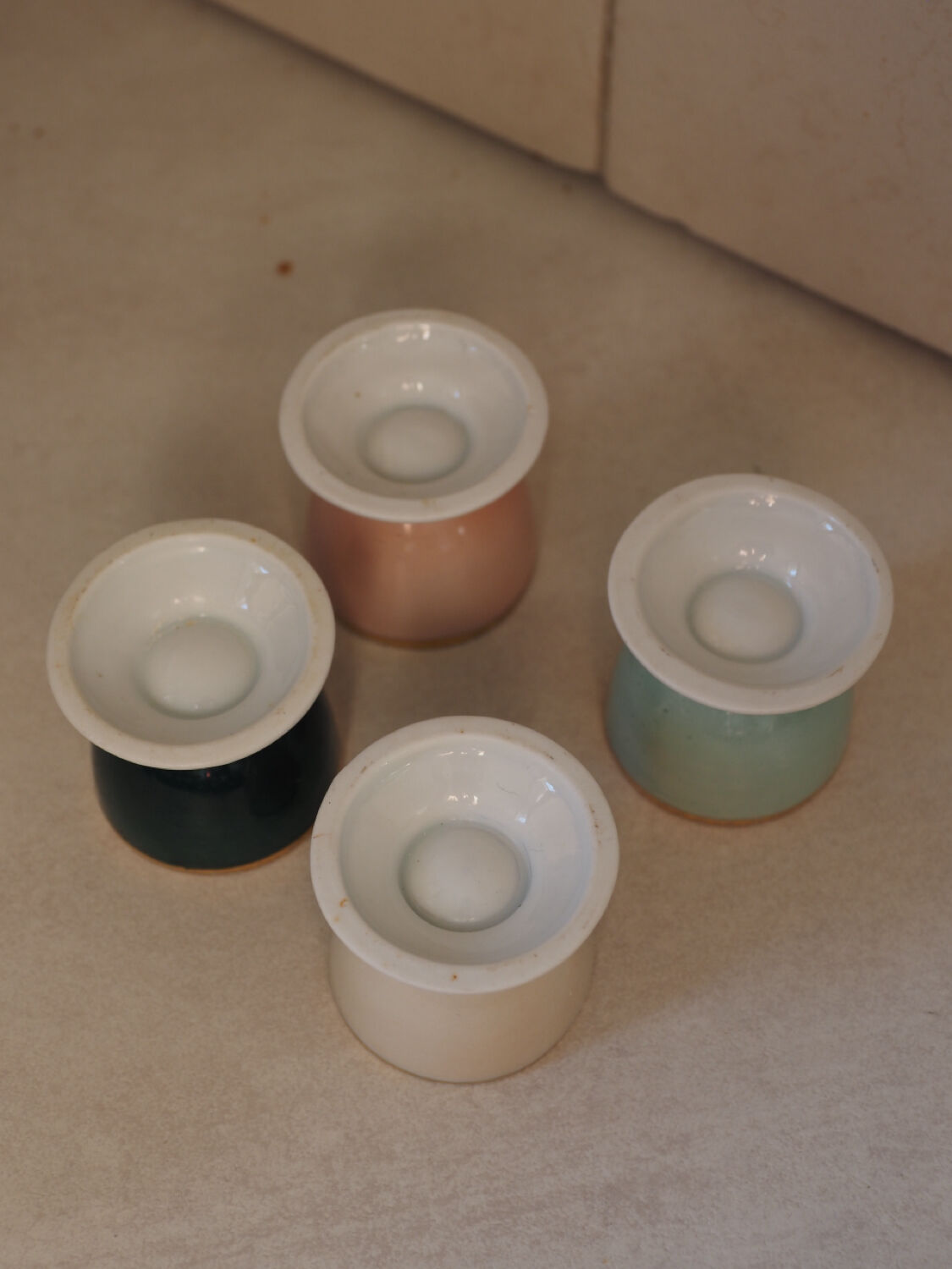 Four coloured egg cups with a golden rim from the 50s.