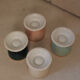 Four coloured egg cups with a golden rim from the 50s.