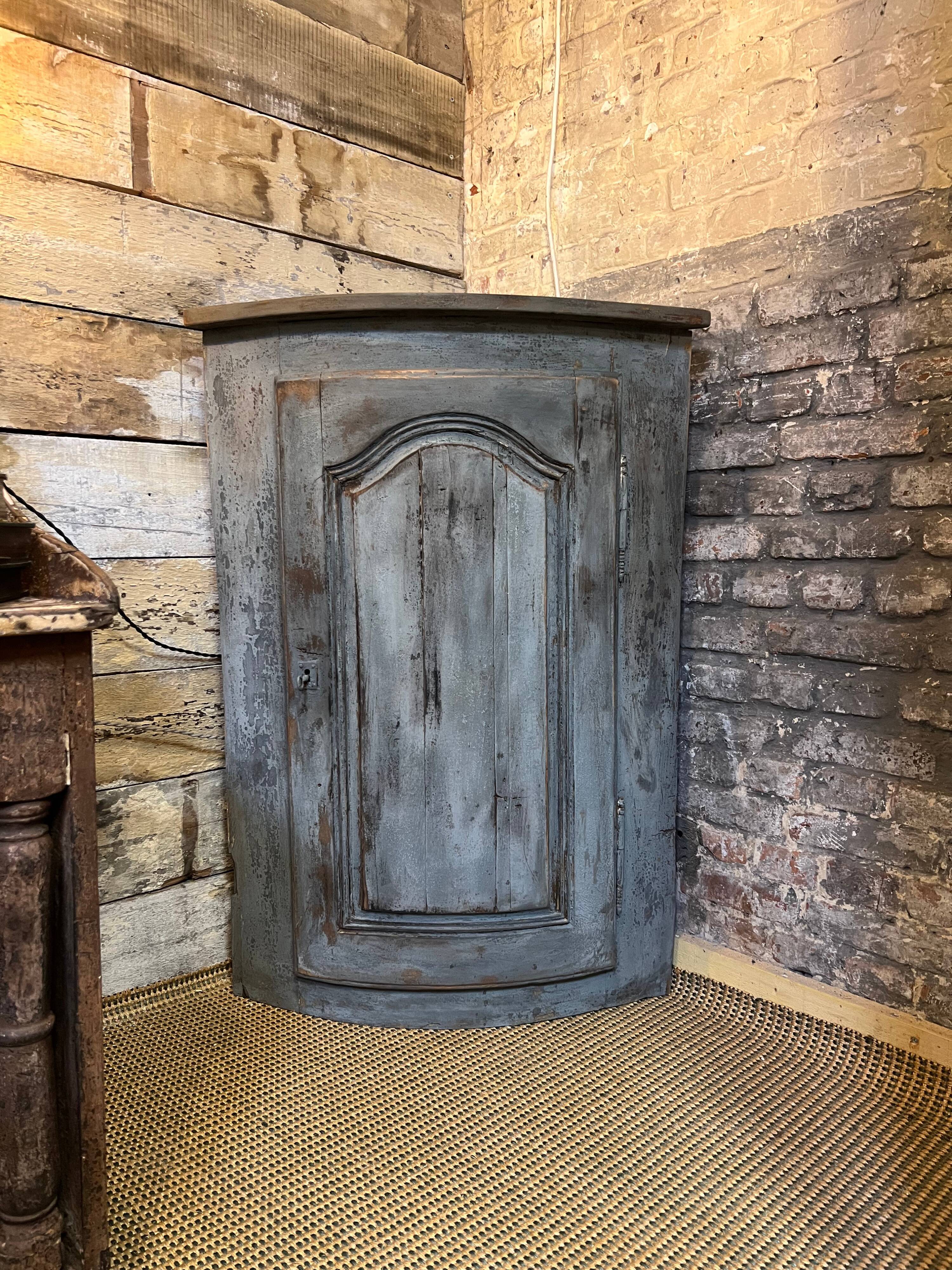 Eighteenth-century corner cabinet with a patina.
