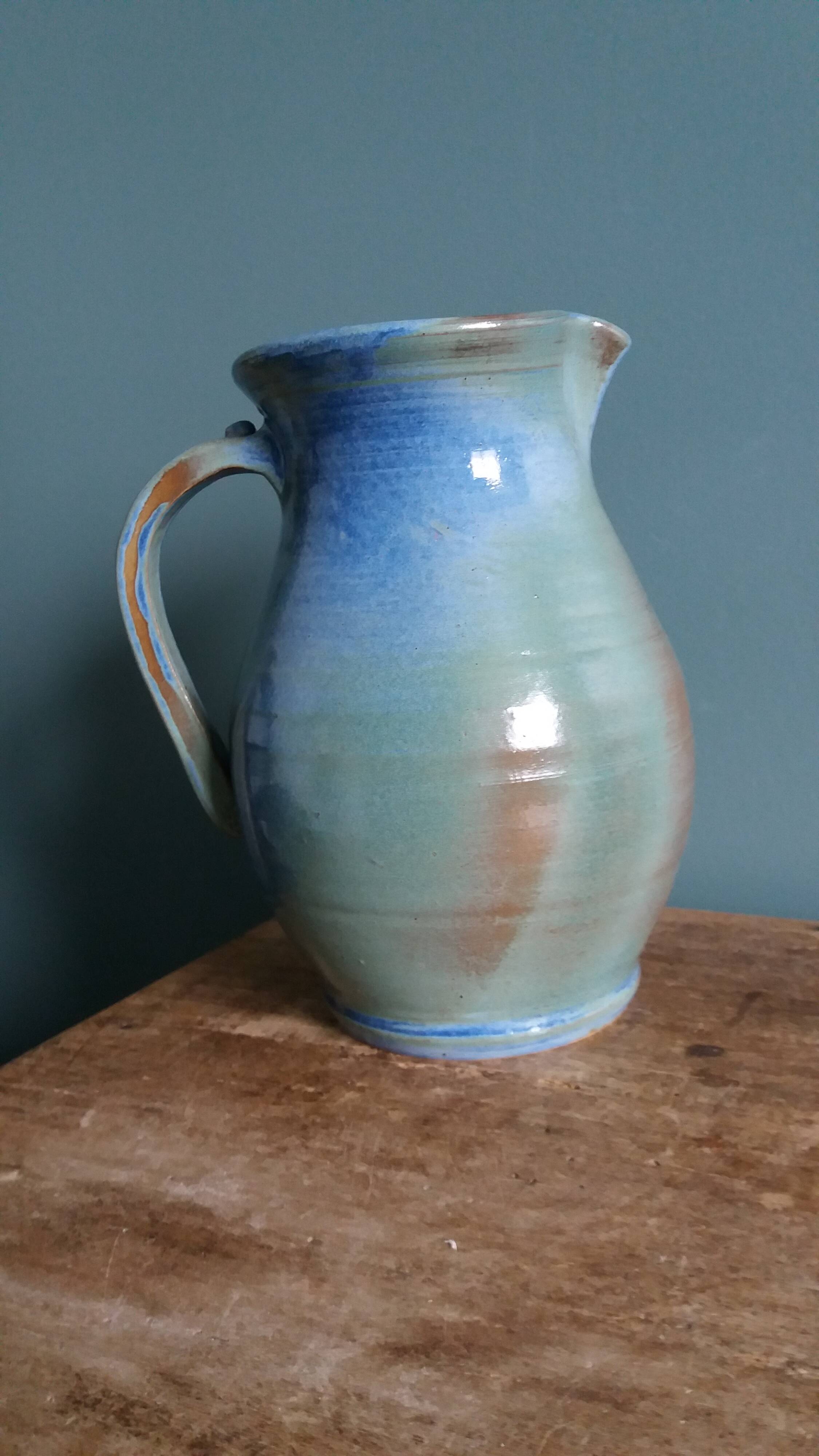 Enamel pitcher in pastel blue and green, signed
