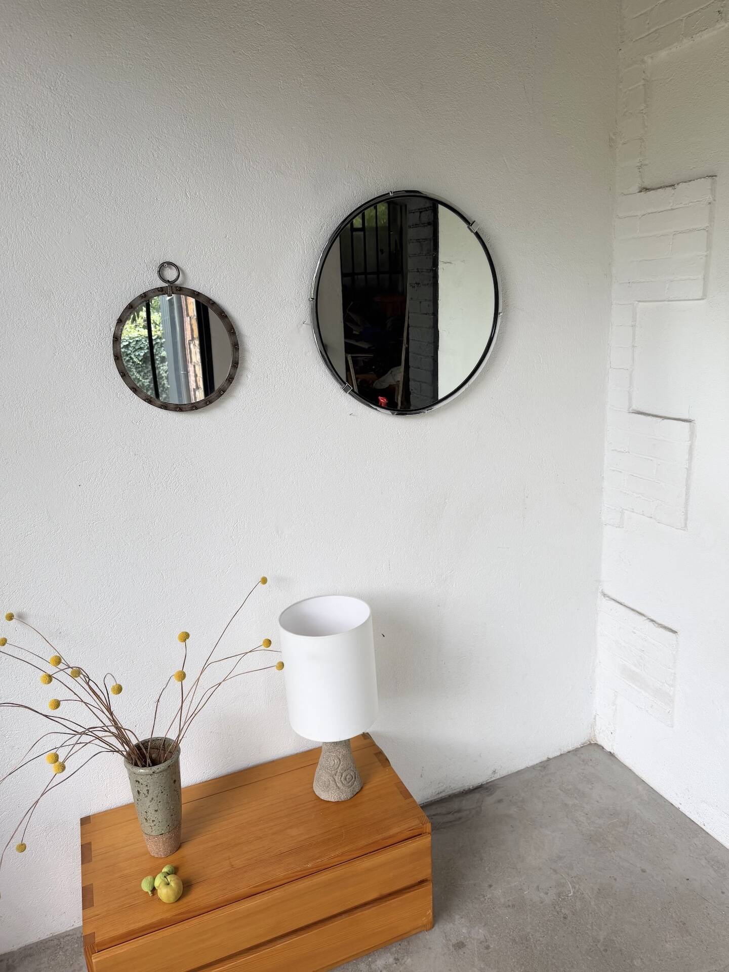 Brutalist round mirror with wrought iron and studs.
