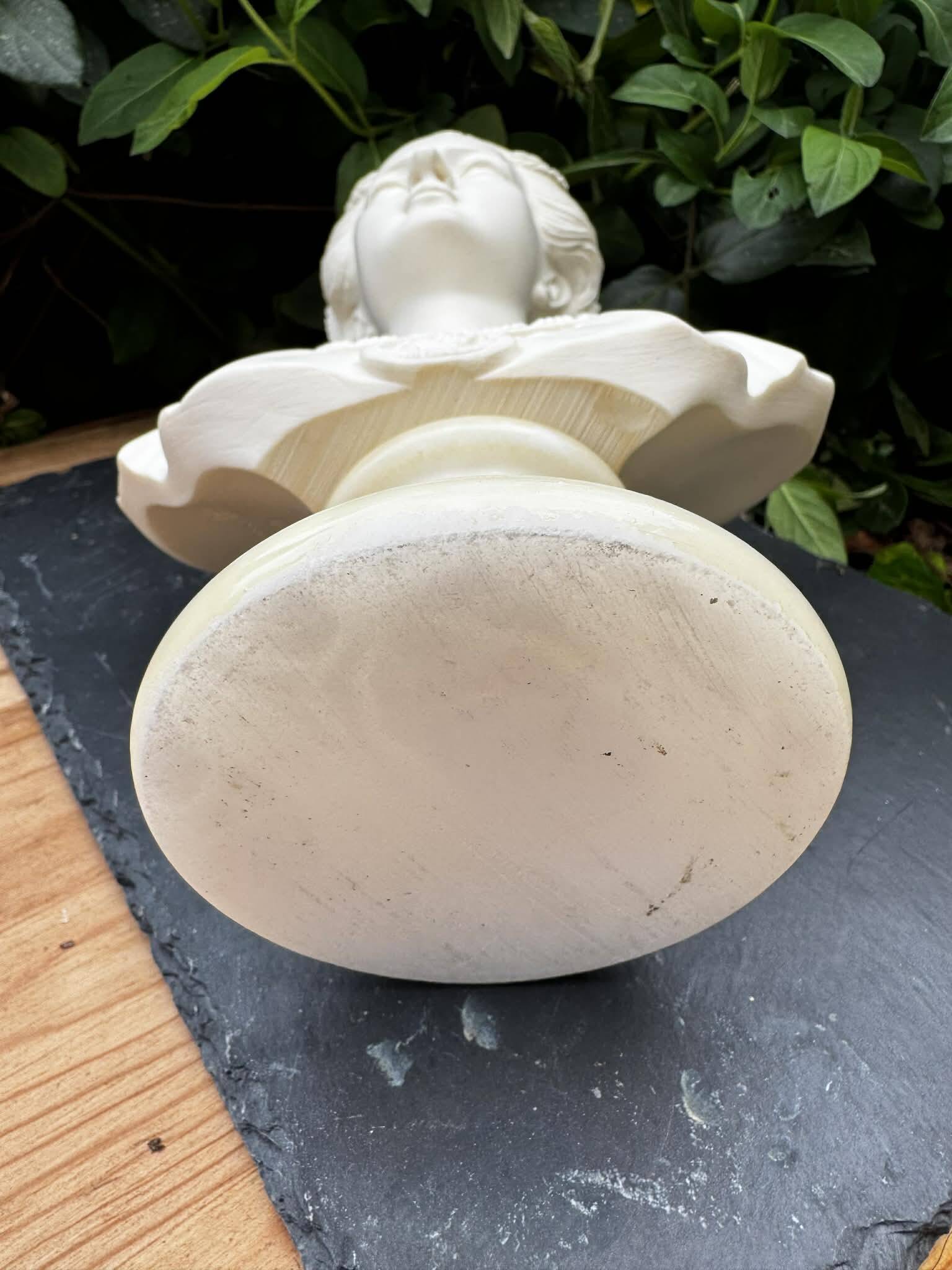 Alabaster bust of a woman signed Arnaldo Giannelli dated 1980.