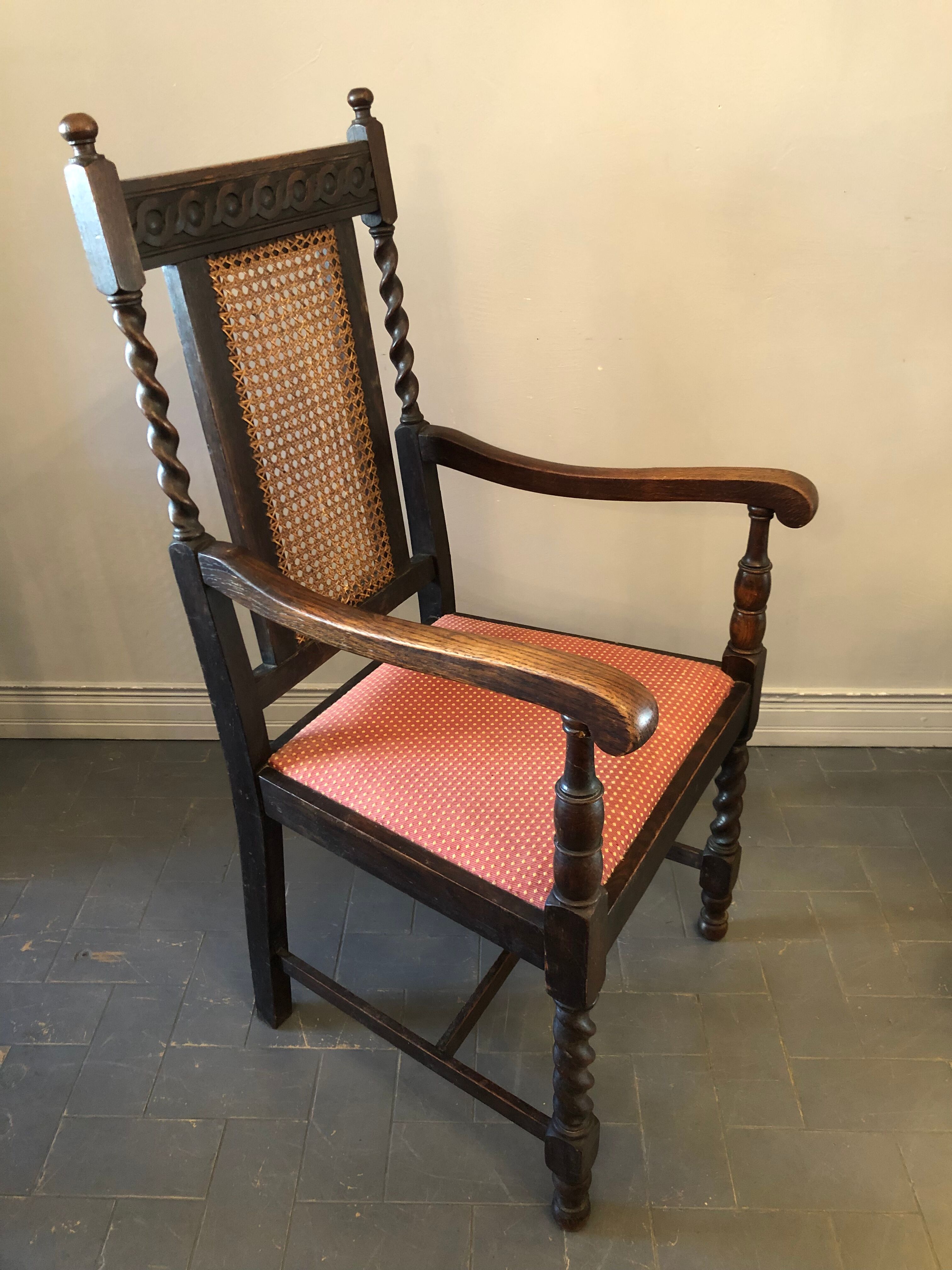 Carved wooden armchair and cannage