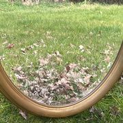 Bevelled golden oval mirror, 79 x 59 cm